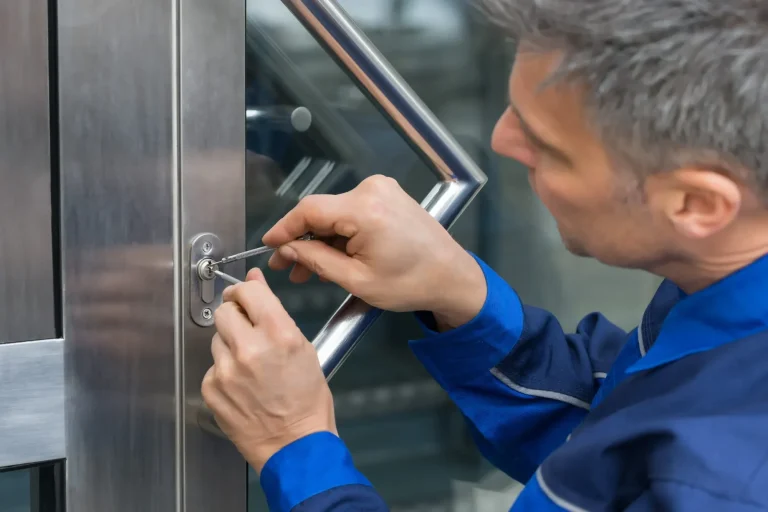 A technician using a tool to unlock a door lock.